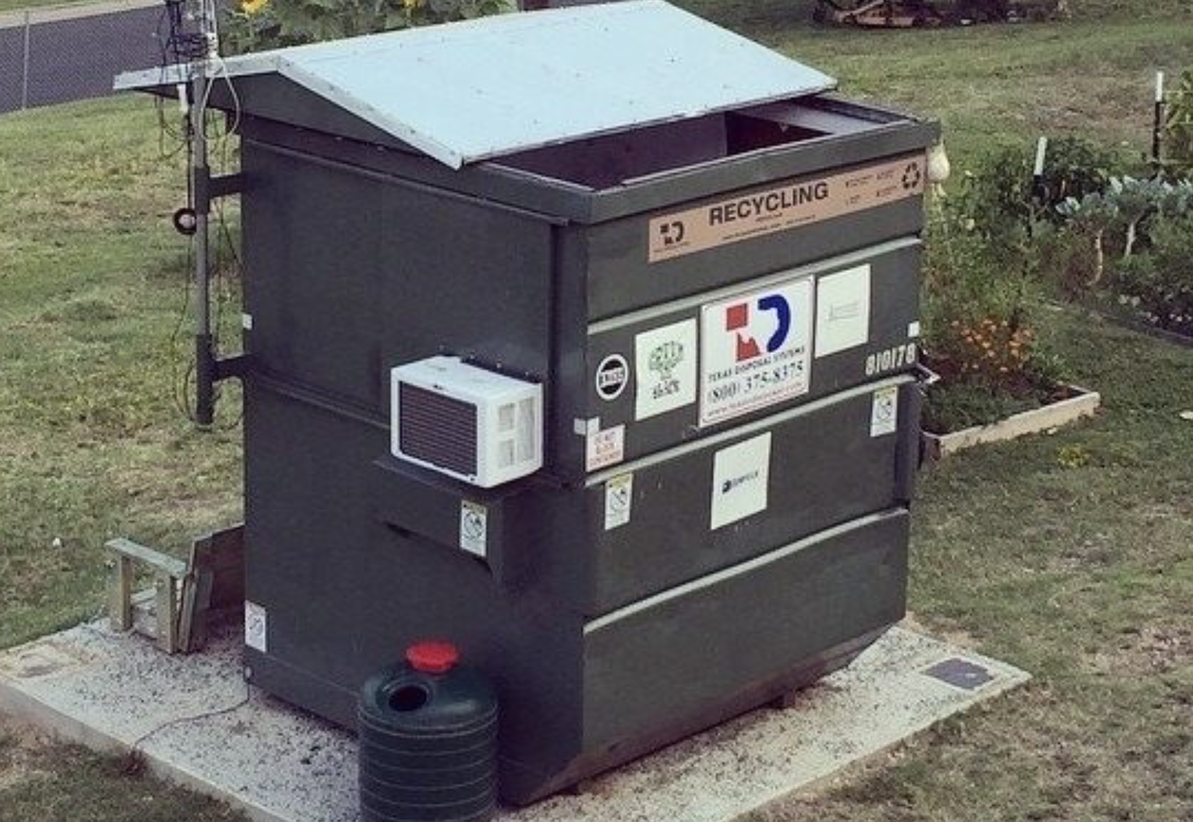 Dumpster exterior with retracting roof and A/C. 